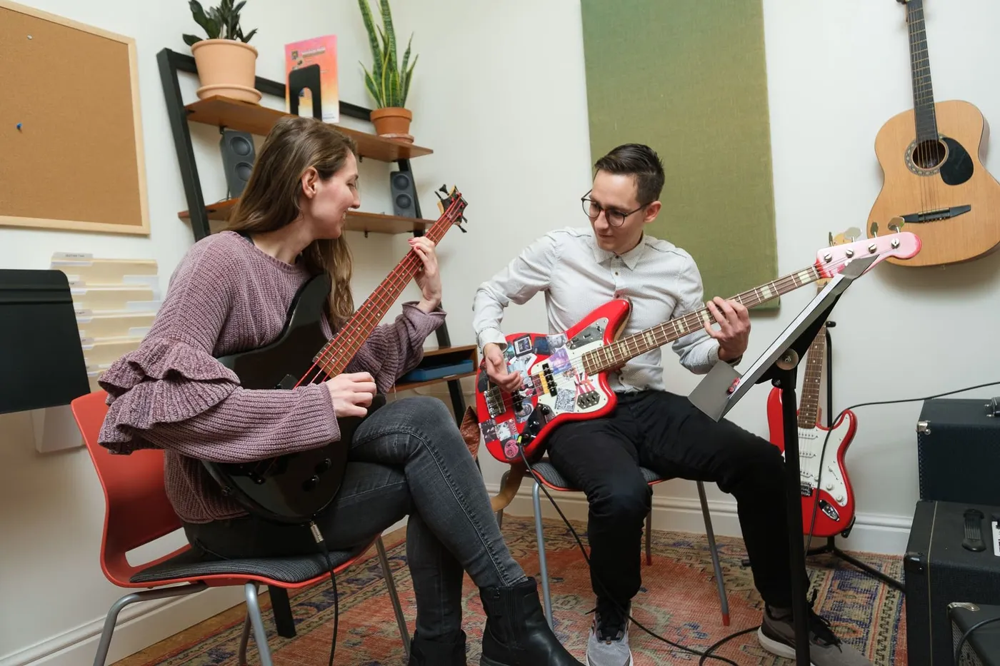 A bass teacher and student play together in a Sunburst lesson room